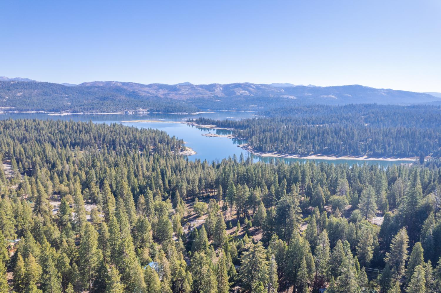 42088 North Elderberry Road Shaver Lake, CA 93664 - Photo 49 of 49 a view of a lush green field with mountains in the background