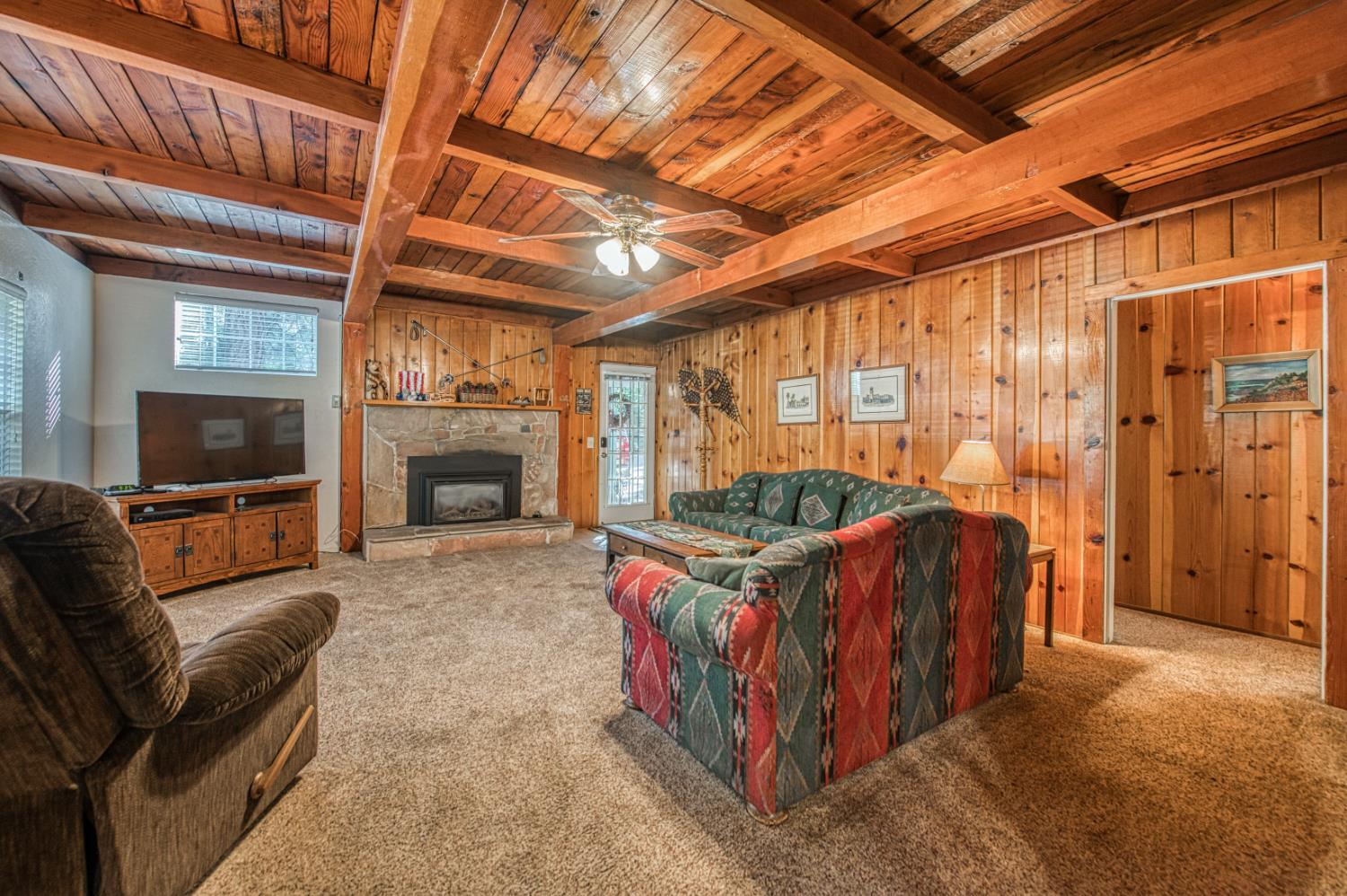 42088 North Elderberry Road Shaver Lake, CA 93664 - Photo 7 of 49 a living room with furniture a flat screen tv and a fireplace