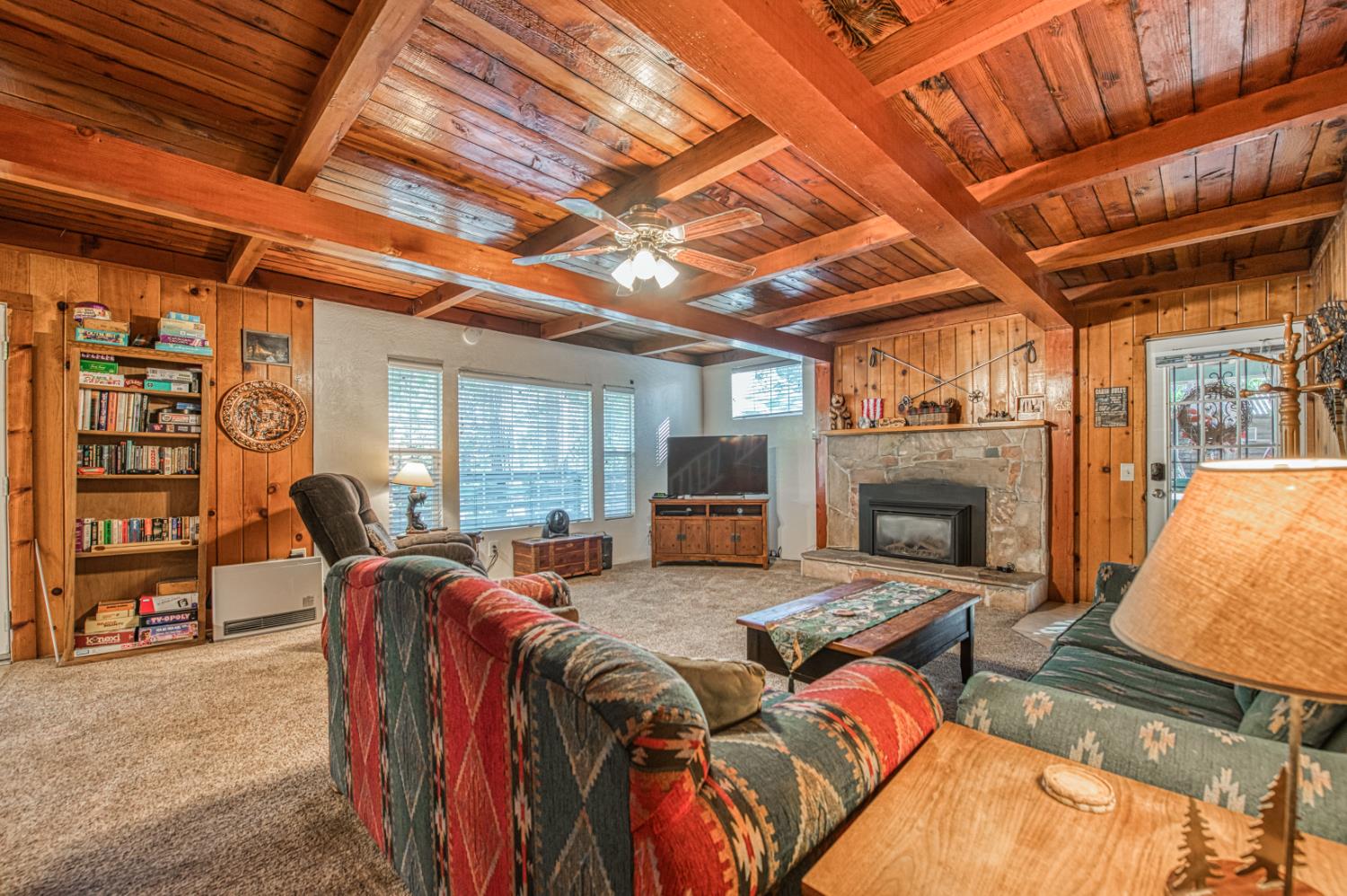 42088 North Elderberry Road Shaver Lake, CA 93664 - Photo 8 of 49 a living room with furniture a fireplace and a flat screen tv