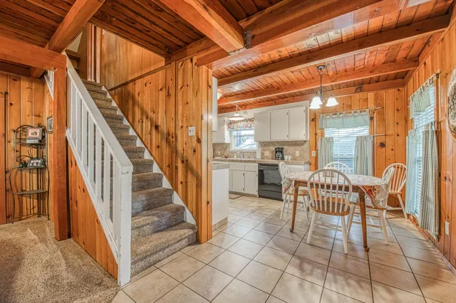 a dining room with furniture and a chandelier