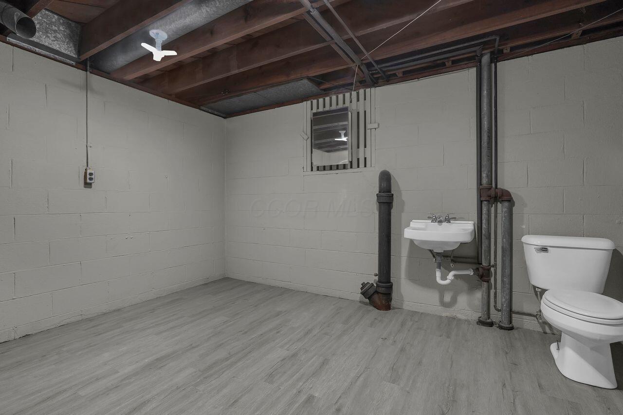 1535 Kenwick Road Columbus, OH 43209 - Photo 19 of 26 Basement half bath with updated flooring, utility sink, and toilet.