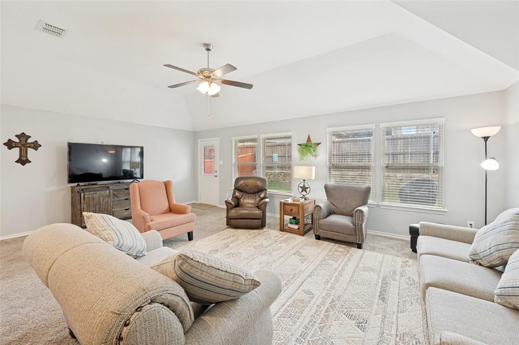 3905 Bridle Path Lane Sanger, TX 76266 - Photo 11 of 26 a living room with furniture a large window and a flat screen tv
