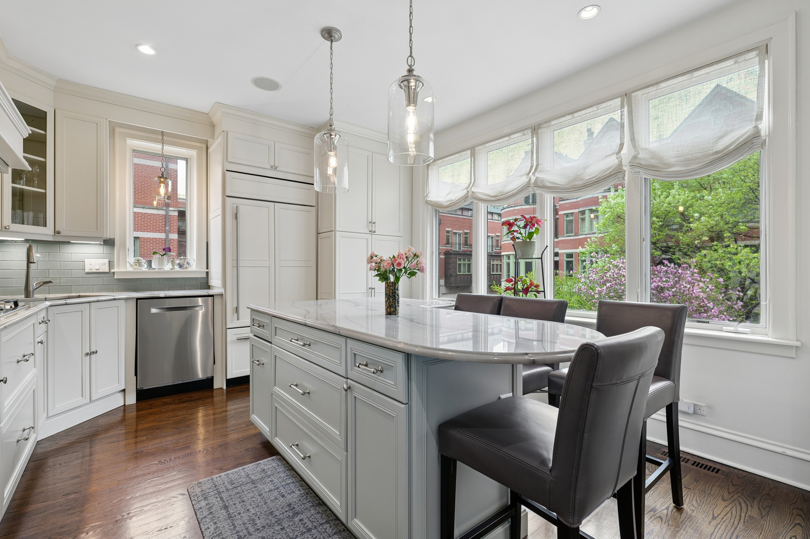 1401 South Indiana Avenue Chicago, IL 60605 - Photo 12 of 40 a kitchen with stainless steel appliances granite countertop a sink a stove a refrigerator dining table and chairs