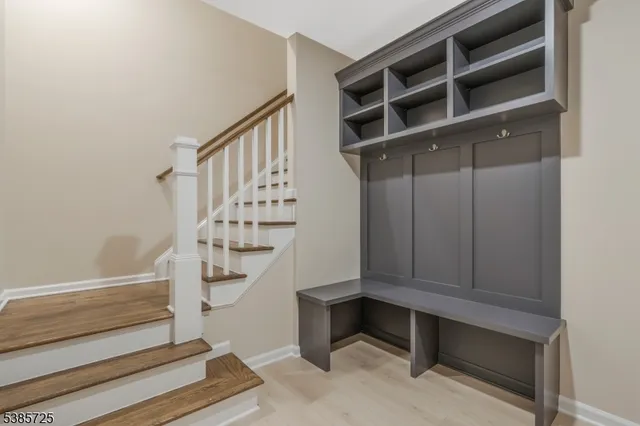 a view of entryway with wooden floor and stairs