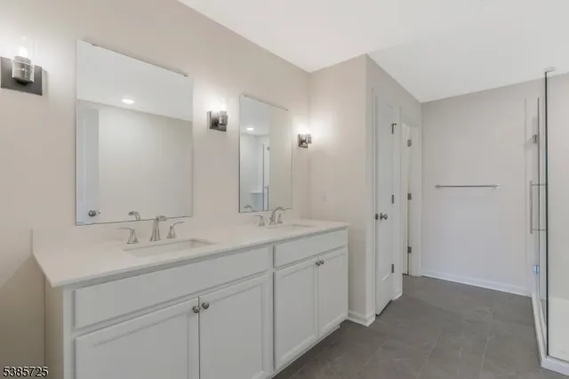 a bathroom with a double vanity sink and mirror
