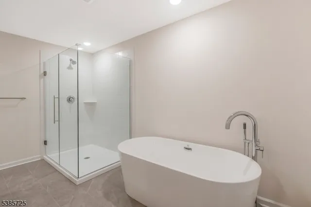 a bathroom with a bathtub and shower
