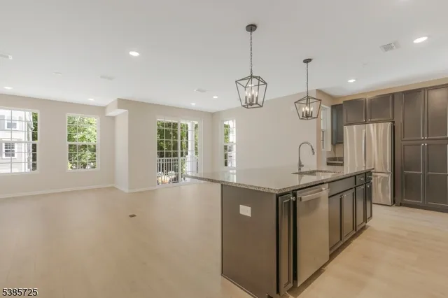 a kitchen with stainless steel appliances granite countertop a stove and a sink
