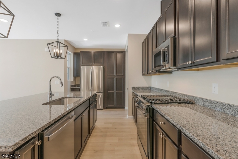 219 Myrtle Road Warren, NJ 07059 - Photo 5 of 33 a kitchen with stainless steel appliances granite countertop a sink a stove and a wooden floors