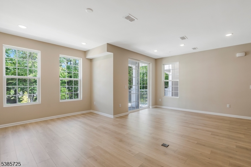 219 Myrtle Road Warren, NJ 07059 - Photo 7 of 33 a view of an empty room with a window and wooden floor