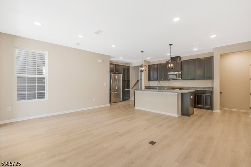 219 Myrtle Road Warren, NJ 07059 - Photo 9 of 33 a large kitchen with a large counter top a sink stainless steel appliances and cabinets