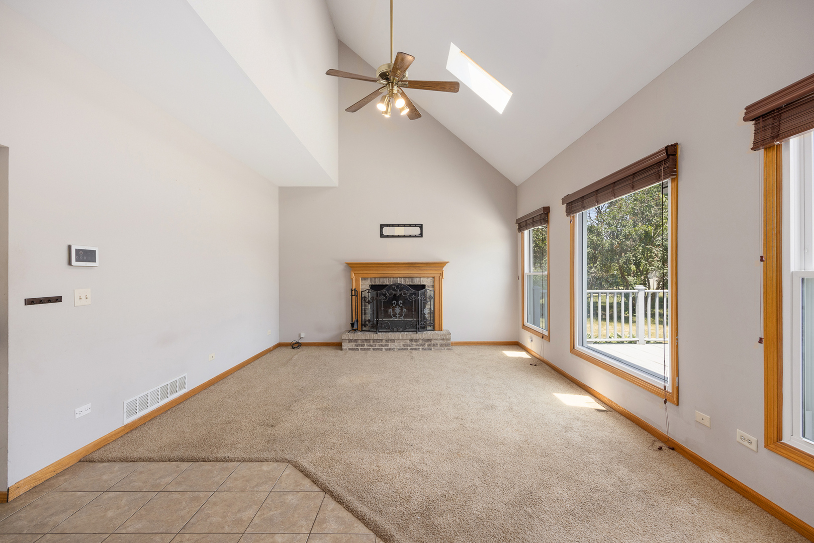 24859 Vermette Road Plainfield, IL 60585 - Photo 12 of 39 a view of an empty room with a fireplace and a window