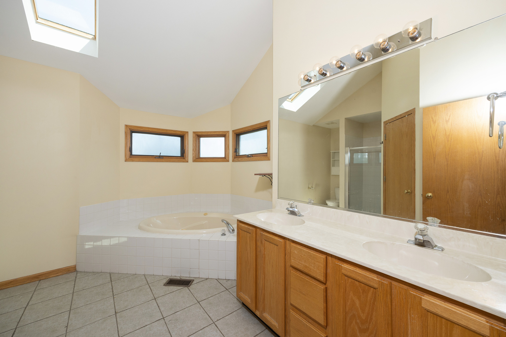 24859 Vermette Road Plainfield, IL 60585 - Photo 17 of 39 a spacious bathroom with a tub sink and mirror