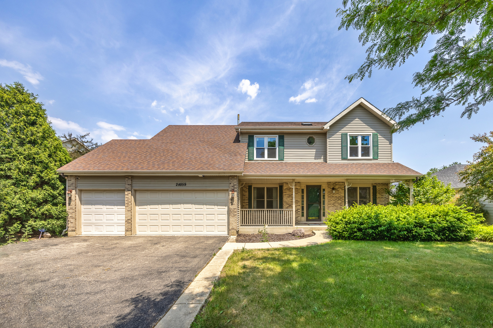 24859 Vermette Road Plainfield, IL 60585 - Photo 3 of 39 a front view of a house with a yard and garage