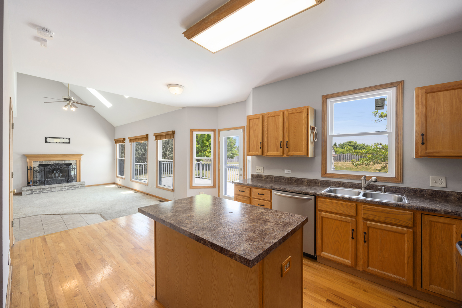 24859 Vermette Road Plainfield, IL 60585 - Photo 8 of 39 a kitchen with stainless steel appliances granite countertop a sink stove and cabinets