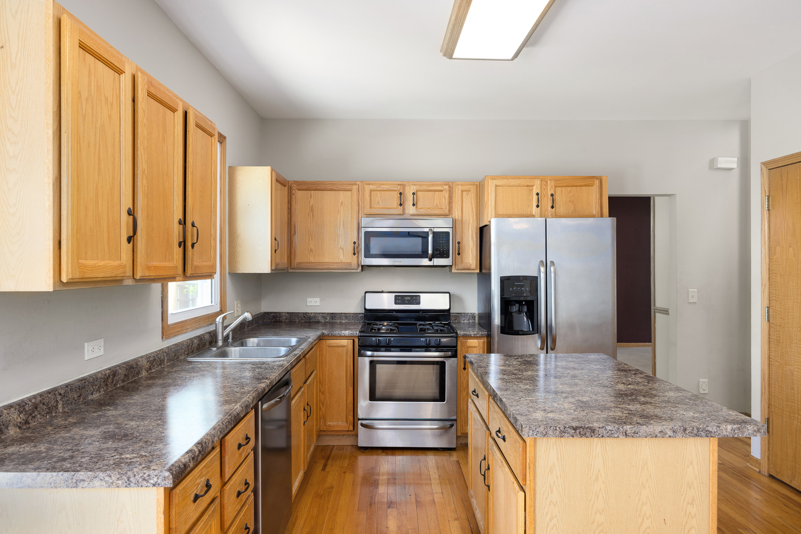 24859 Vermette Road Plainfield, IL 60585 - Photo 9 of 39 a kitchen with stainless steel appliances granite countertop a sink stove and refrigerator