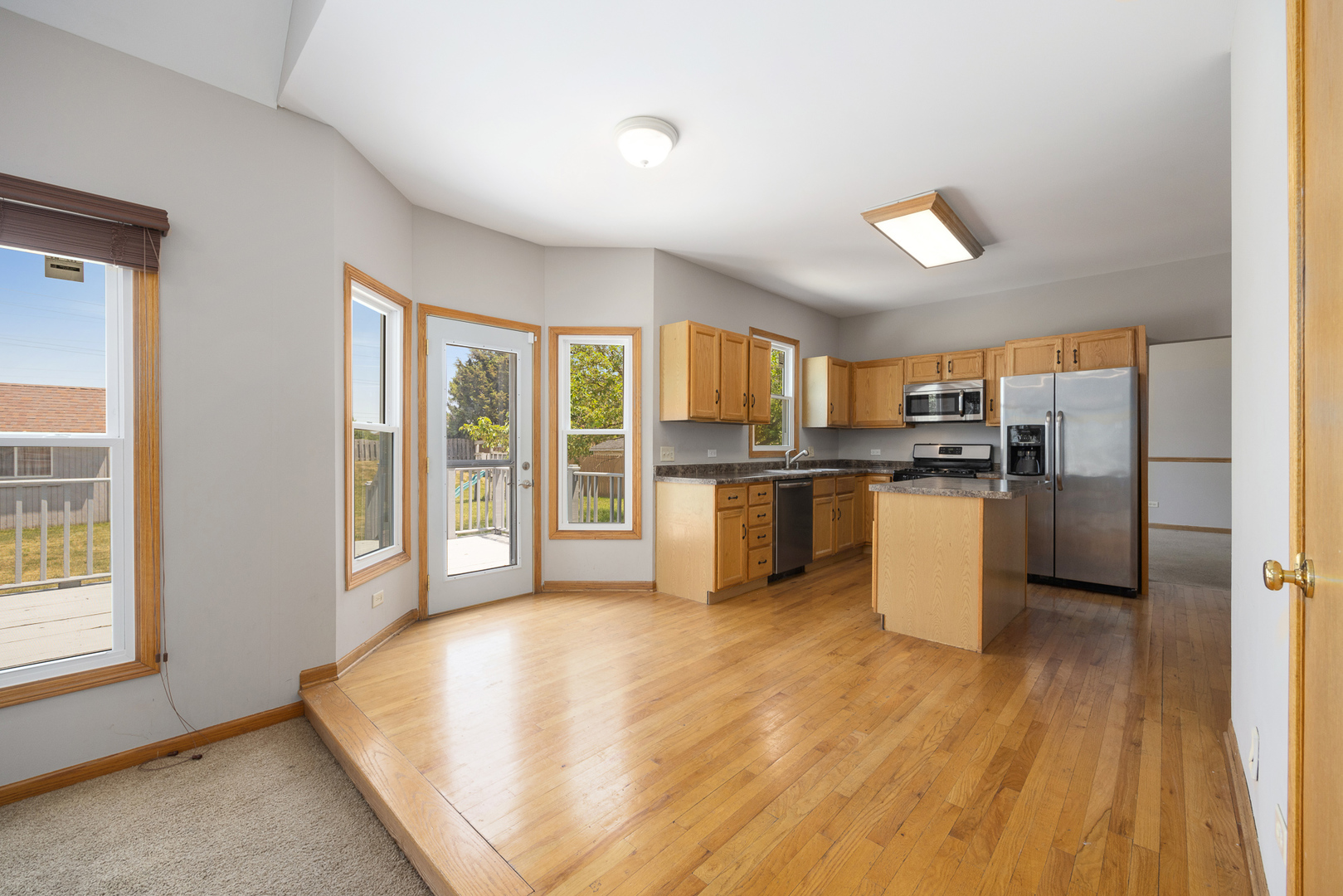 24859 Vermette Road Plainfield, IL 60585 - Photo 10 of 39 a kitchen with stainless steel appliances a refrigerator and wooden cabinets