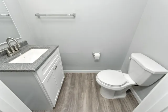 a white toilet sitting next to a bathroom sink