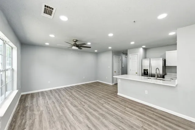 a view of kitchen with cabinets and wooden floor