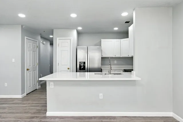 a large kitchen with kitchen island a sink stainless steel appliances and cabinets