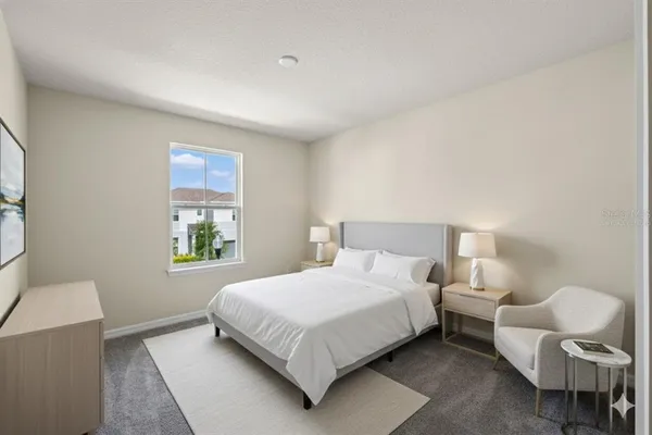 a bedroom with a bed and chair