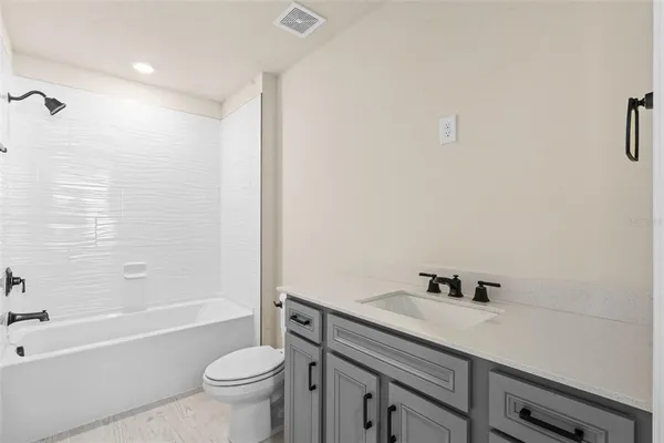 a bathroom with a sink a toilet and a bathtub