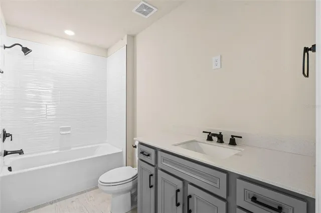 a bathroom with a sink a toilet and a bathtub