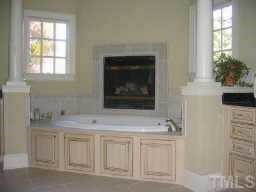 6301 Swallow Cove Lane Raleigh, NC 27614 - Photo 9 of 12 Jacuzzi tub accented by columns and a fireplace, Bisque cabinets with cholocate glaze, and decorator mirrors. Other