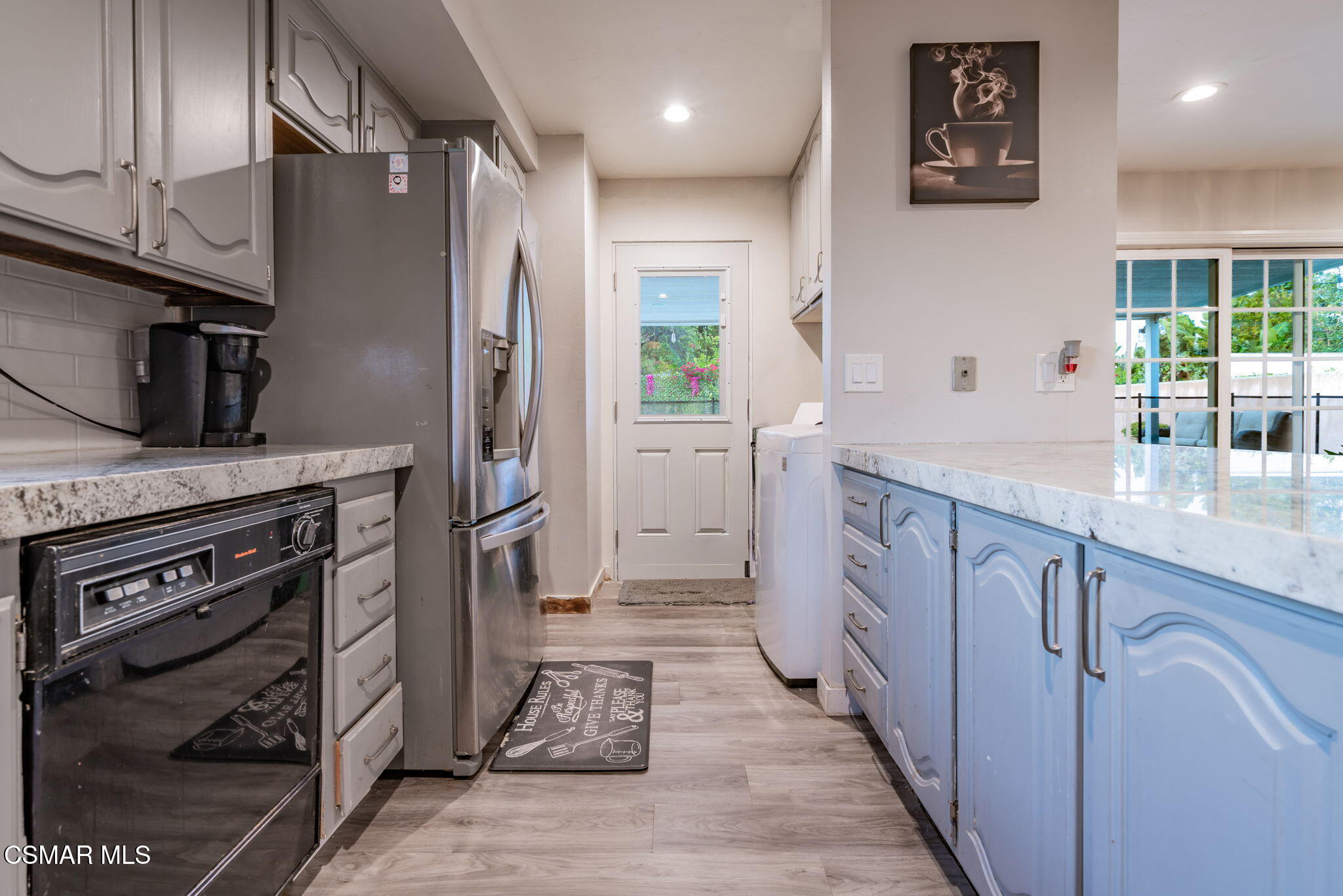 761 Lyons Court Simi Valley, CA 93065 - Photo 23 of 61 a kitchen with cabinets and stainless steel appliances