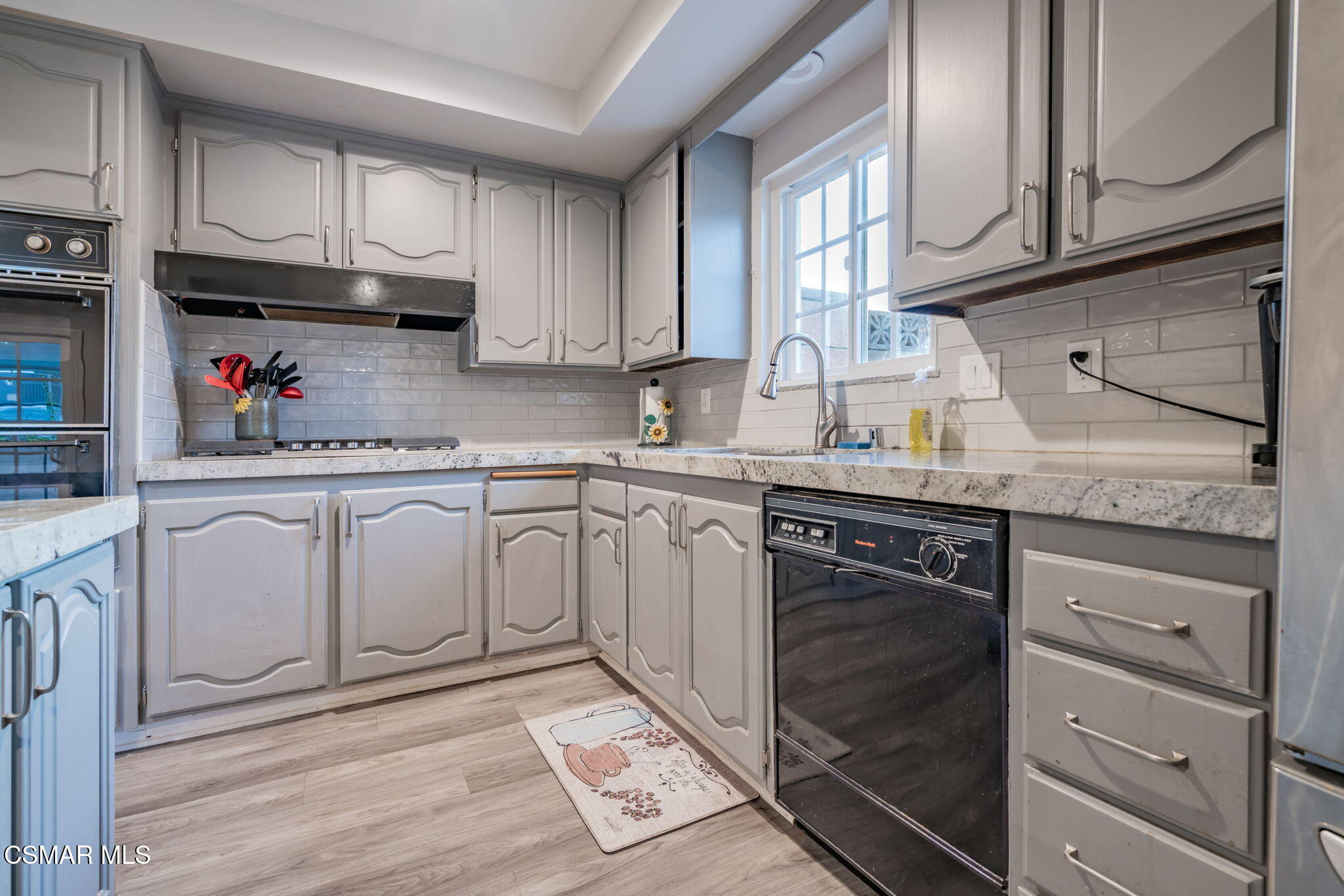 761 Lyons Court Simi Valley, CA 93065 - Photo 25 of 61 a kitchen with granite countertop a sink cabinets stainless steel appliances and a window