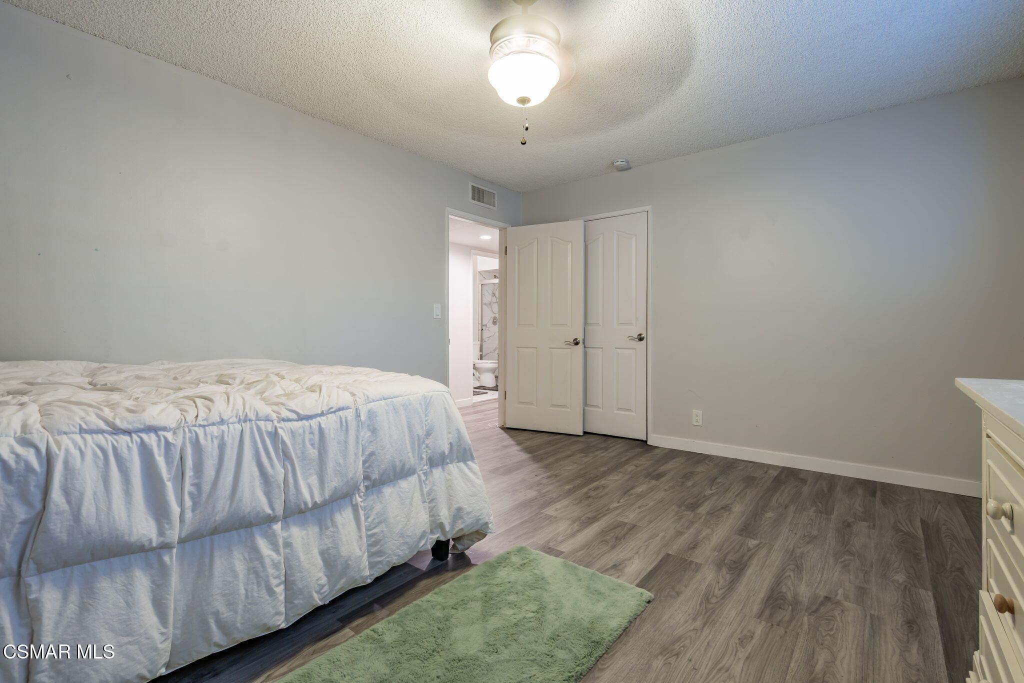 761 Lyons Court Simi Valley, CA 93065 - Photo 35 of 61 a spacious bedroom with a bed and a chandelier
