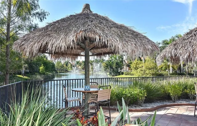 a view of a patio with two chairs next to a yard