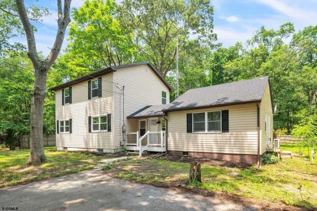 a house that has a tree in front of the house