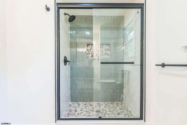 a bathroom with a glass shower door