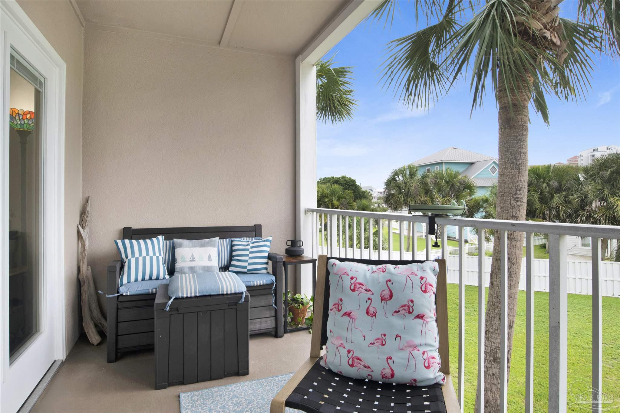 13351 Johnson Beach Road, Unit 203E Perdido Key, FL 32507 - Photo 27 of 55 a balcony with furniture and a potted plant