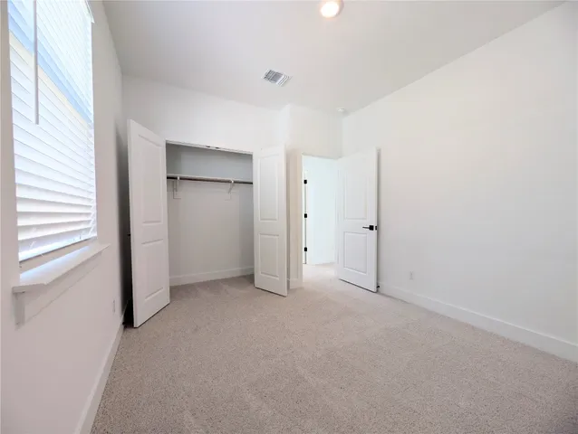 an empty room with closet area