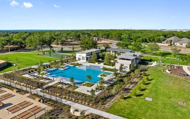 a view of a house with a backyard patio and swimming pool
