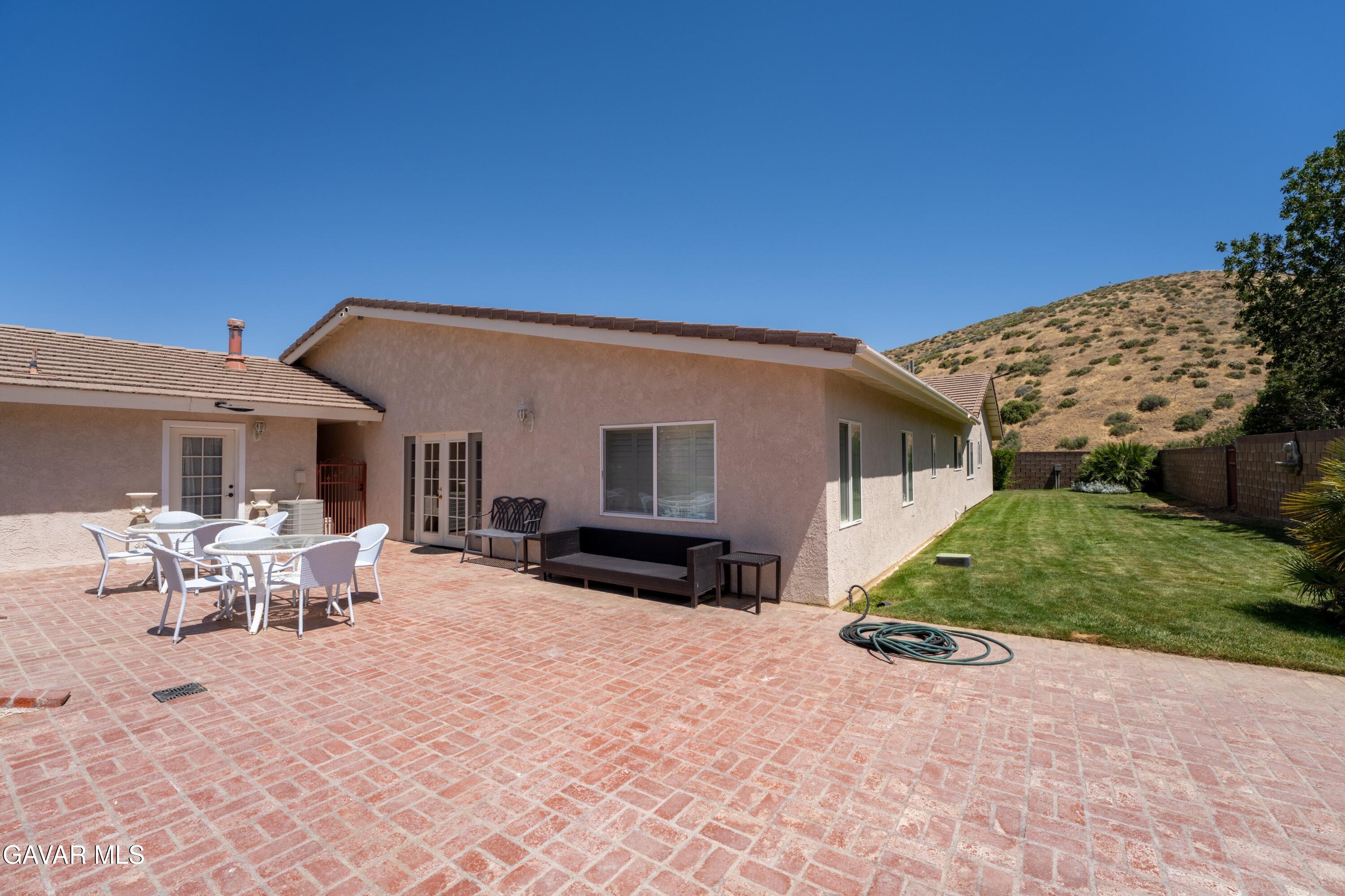 5801 Hacienda Ranch Road Palmdale, CA 93551 - Photo 59 of 69 a view of a house with backyard and sitting area