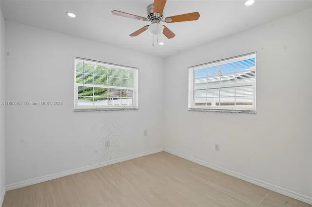a view of a livingroom with a ceiling fan and refrigerator