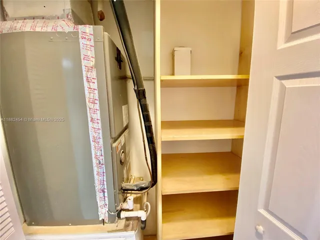 a view of a pathway of a house with potted plants