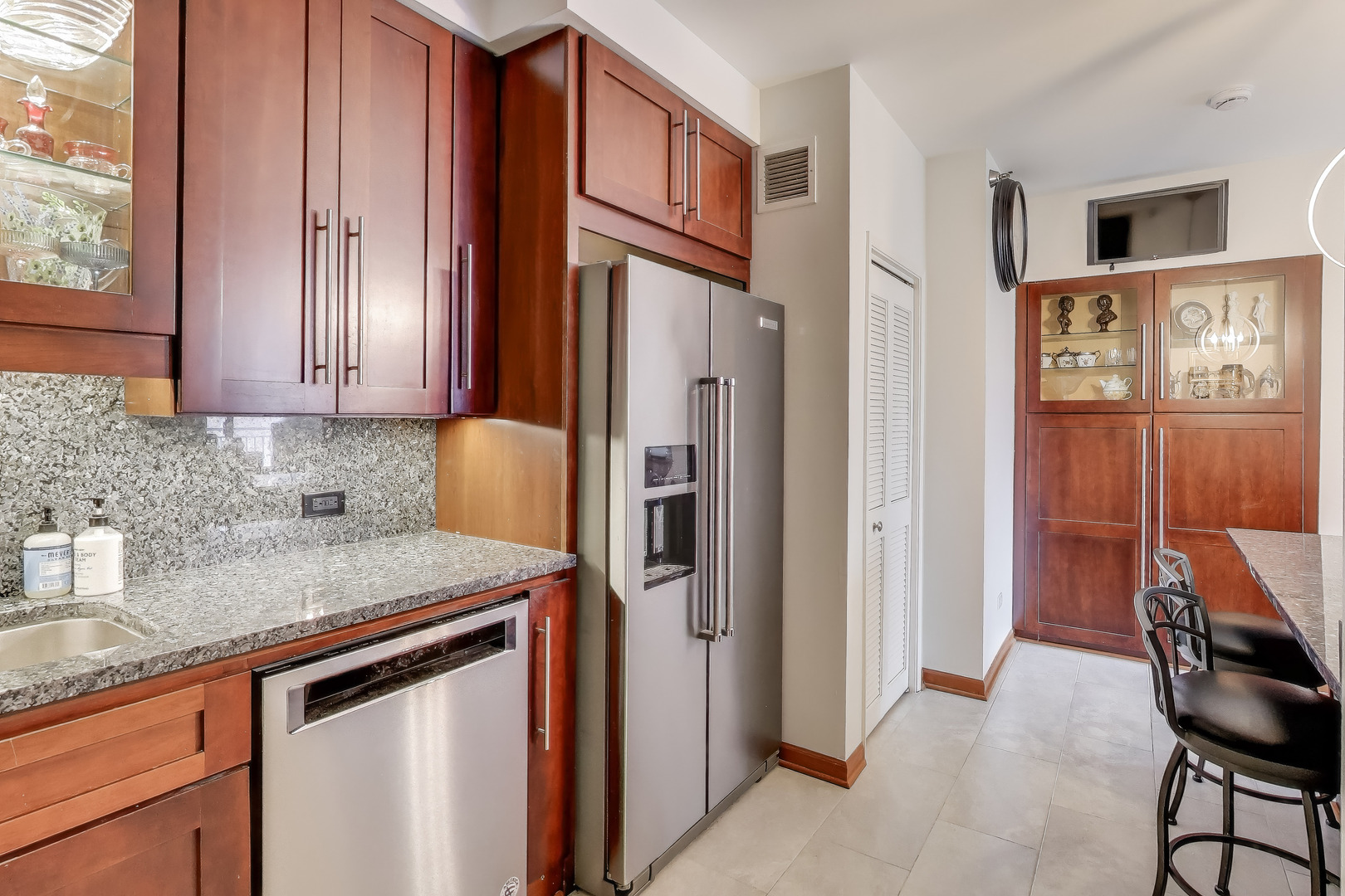 55 West Delaware Place, Unit 810 Chicago, IL 60610 - Photo 11 of 29 a kitchen with stainless steel appliances granite countertop a refrigerator and a sink