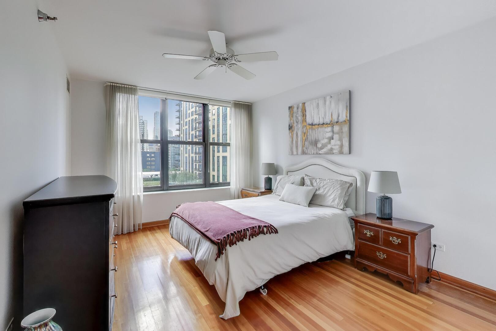 55 West Delaware Place, Unit 810 Chicago, IL 60610 - Photo 12 of 29 a bedroom with a bed and wooden floor