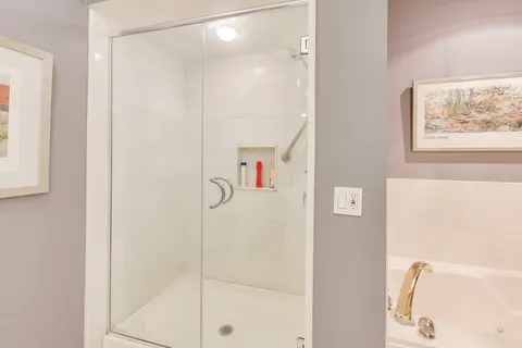 a bathroom with a shower and a sink