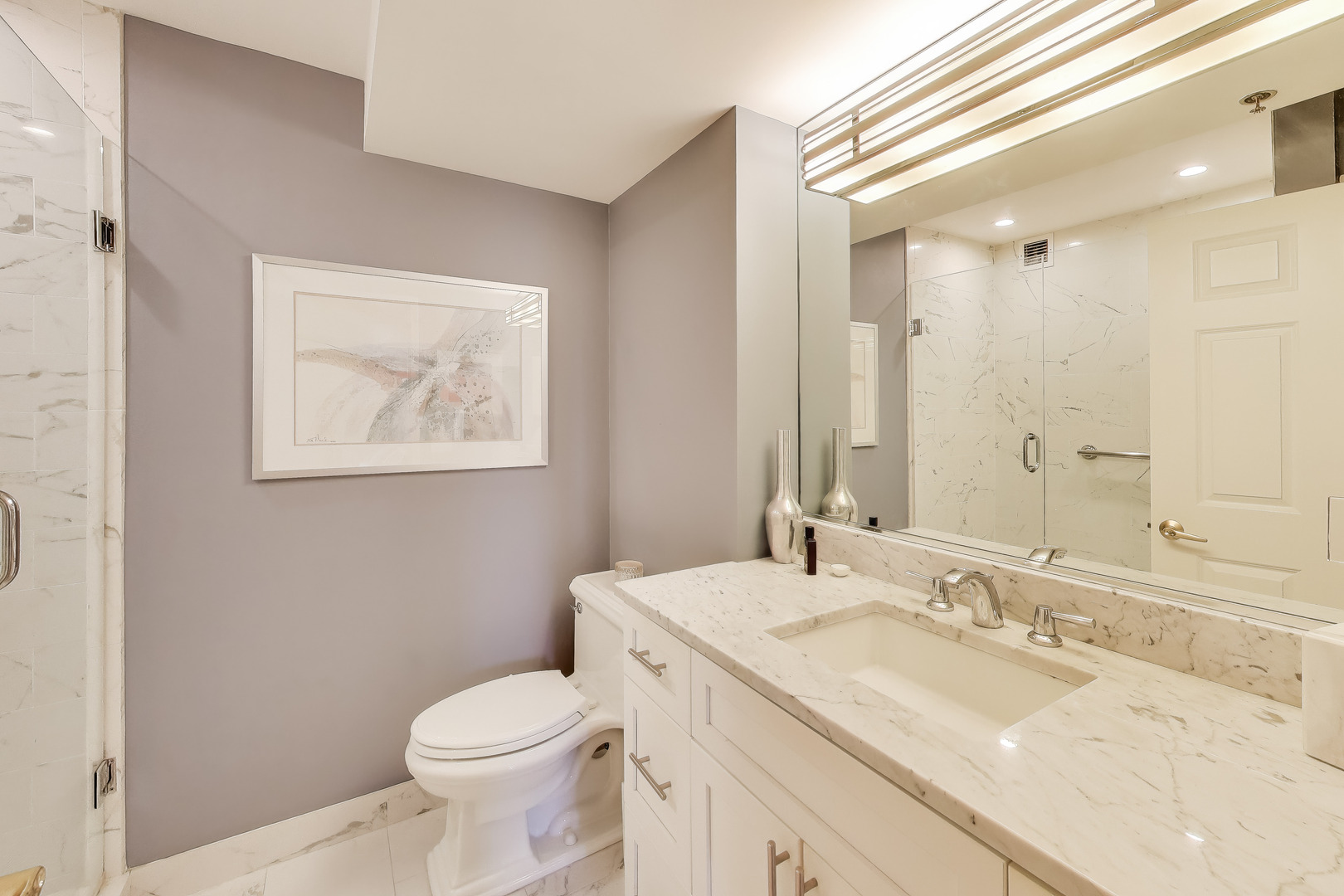 55 West Delaware Place, Unit 810 Chicago, IL 60610 - Photo 20 of 29 a bathroom with a granite countertop sink mirror vanity and toilet