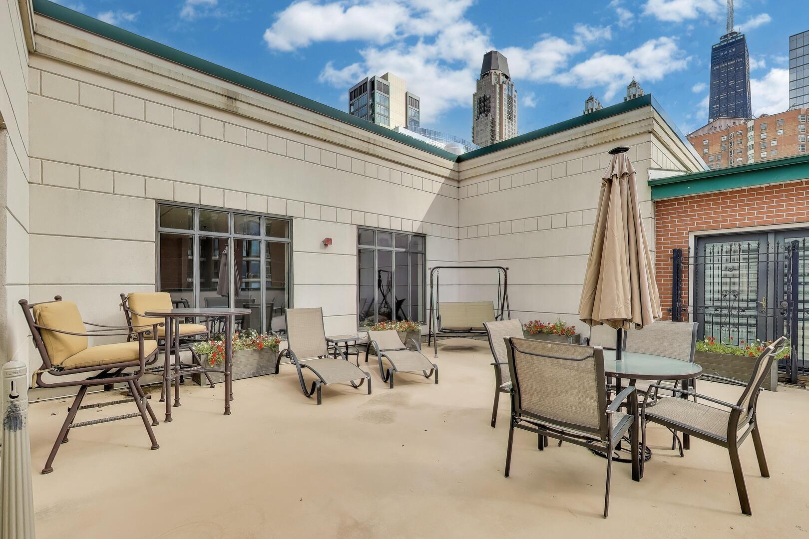 55 West Delaware Place, Unit 810 Chicago, IL 60610 - Photo 26 of 29 a view of a patio with a table and chairs