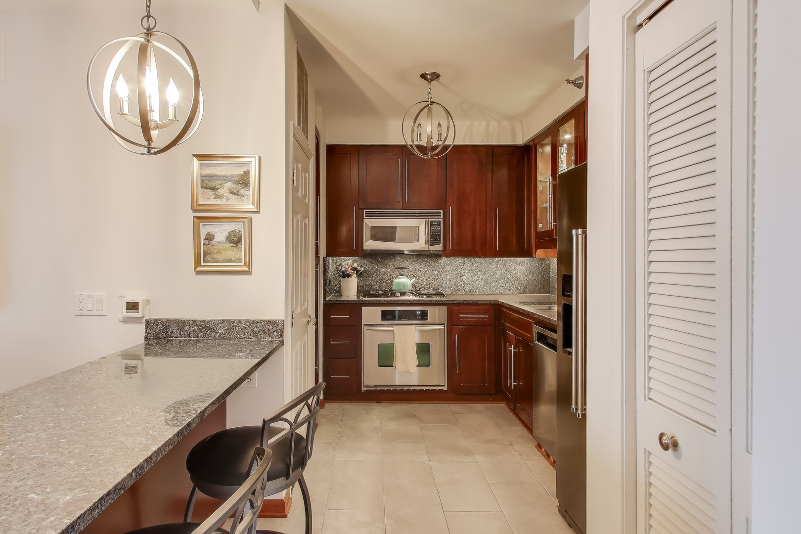 55 West Delaware Place, Unit 810 Chicago, IL 60610 - Photo 9 of 29 a kitchen with granite countertop stainless steel appliances a stove a sink and cabinets