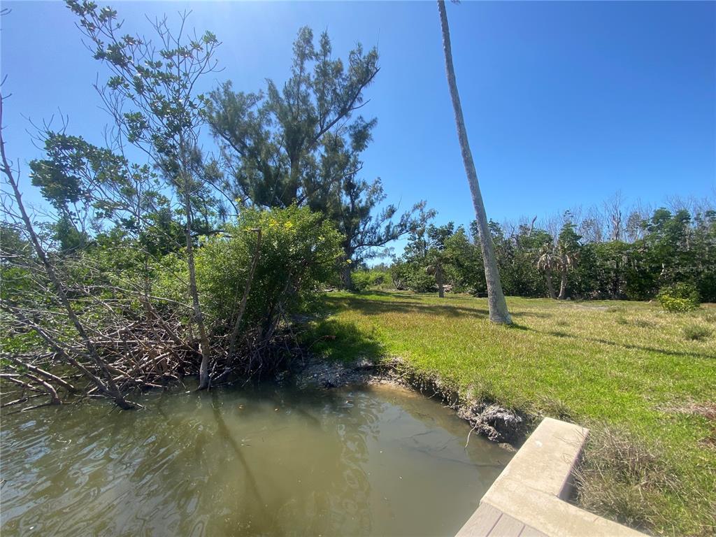 7 Access Undetermined Boca Grande, FL 33921 - Photo 10 of 33 a view of a lake with a yard