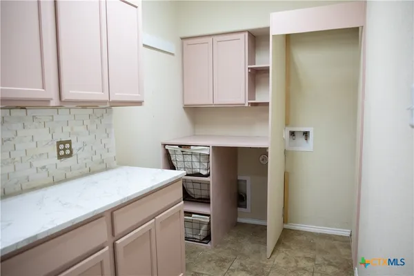 a kitchen with a sink and cabinets