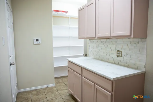a kitchen with a sink cabinets and utility