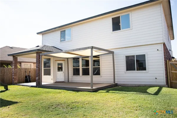a view of a house with pool and a yard
