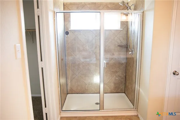 a bathroom with a glass shower door
